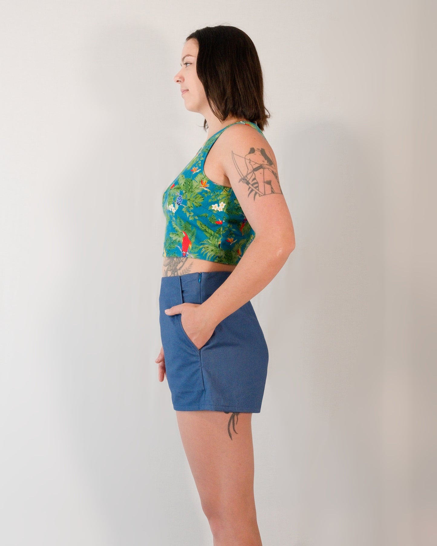 Left side of Kingfisher A-line shorts in dark blue. Model has hand in pocket.