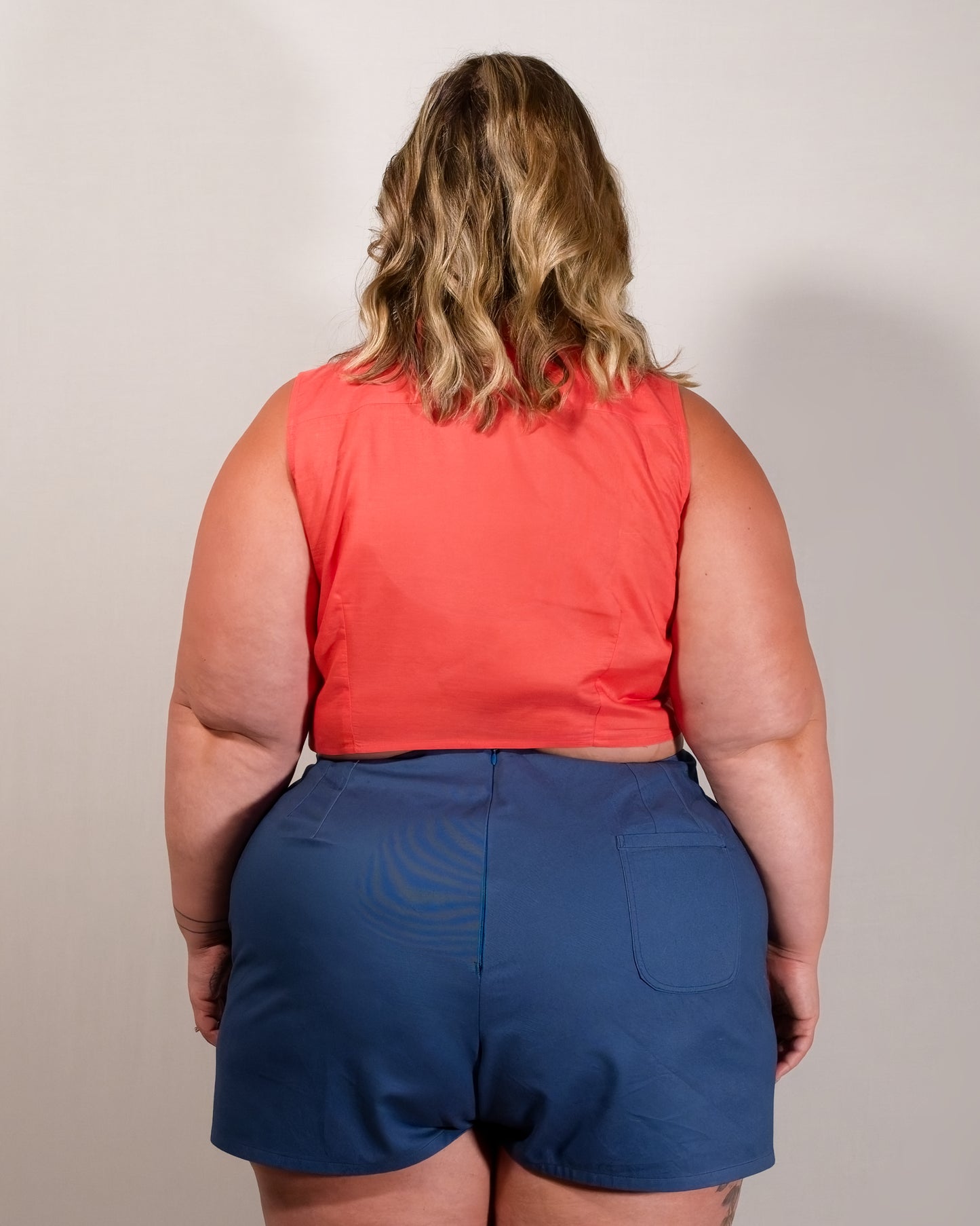 Back of Kingfisher A-line shorts in dark blue. Hidden zipper closure centre-back and a single back pocket on the right.