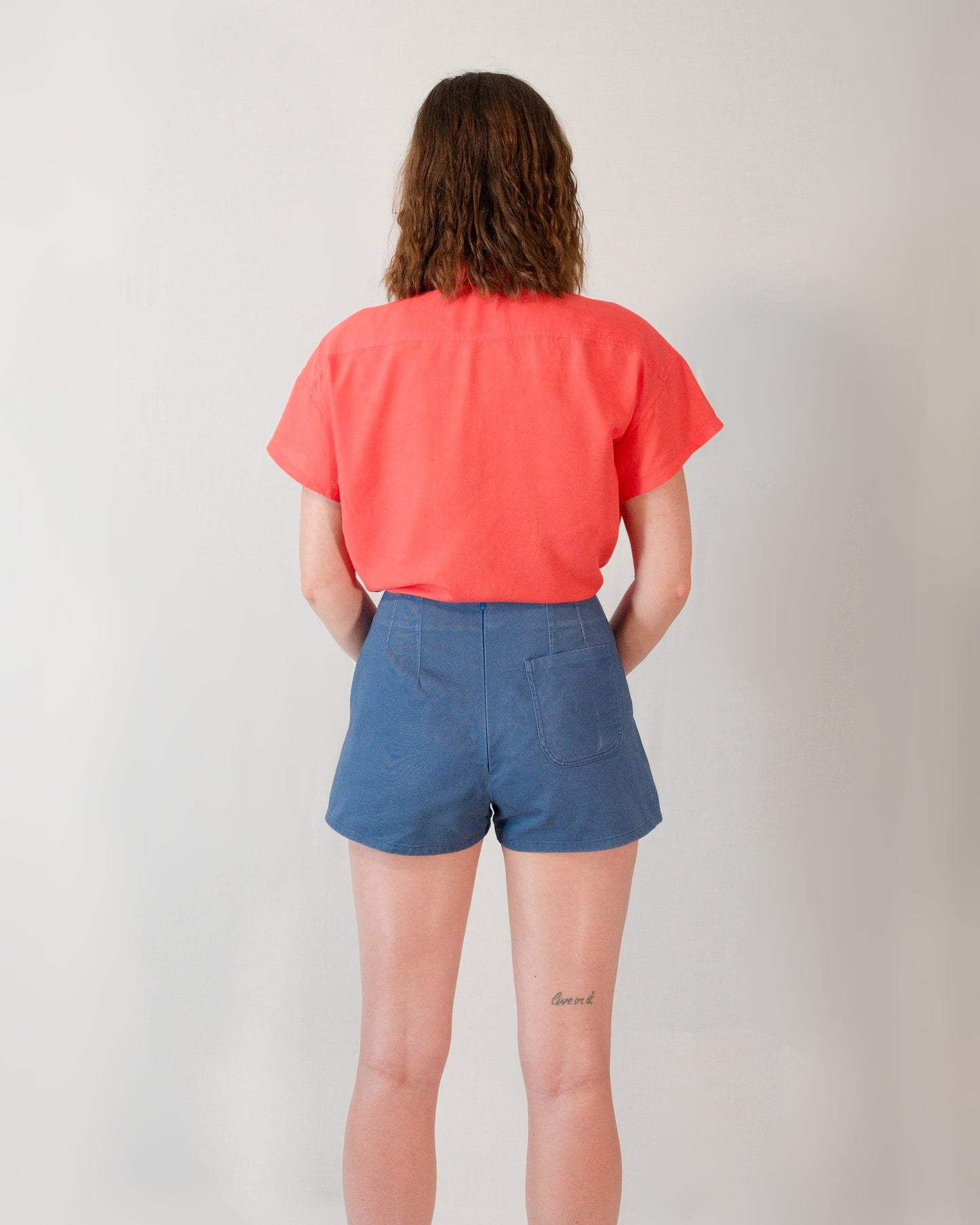 Back of Kingfisher A-line shorts in dark blue. Hidden zip closure centre-back and one back pocket on the right.