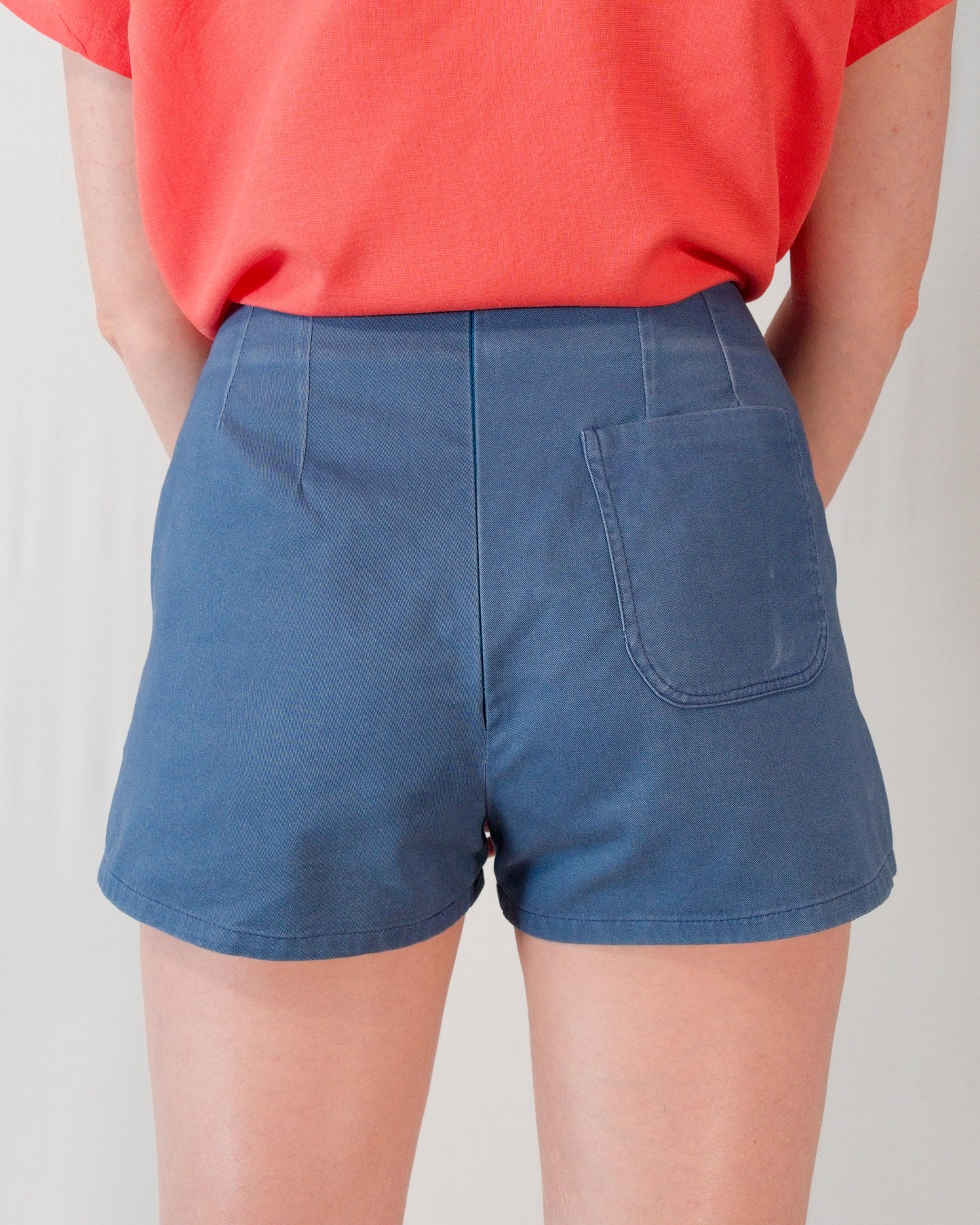 Back of Kingfisher A-line shorts in dark blue. Hidden zip closure centre-back and one back pocket on the right.