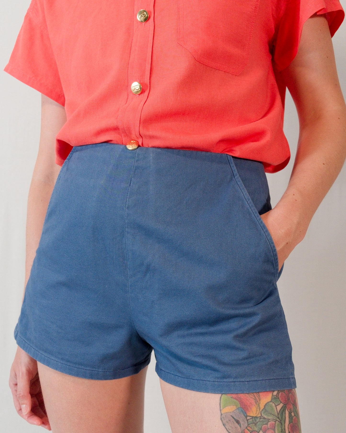 Front of Kingfisher A-line shorts in dark blue. Model has hand in left pocket.