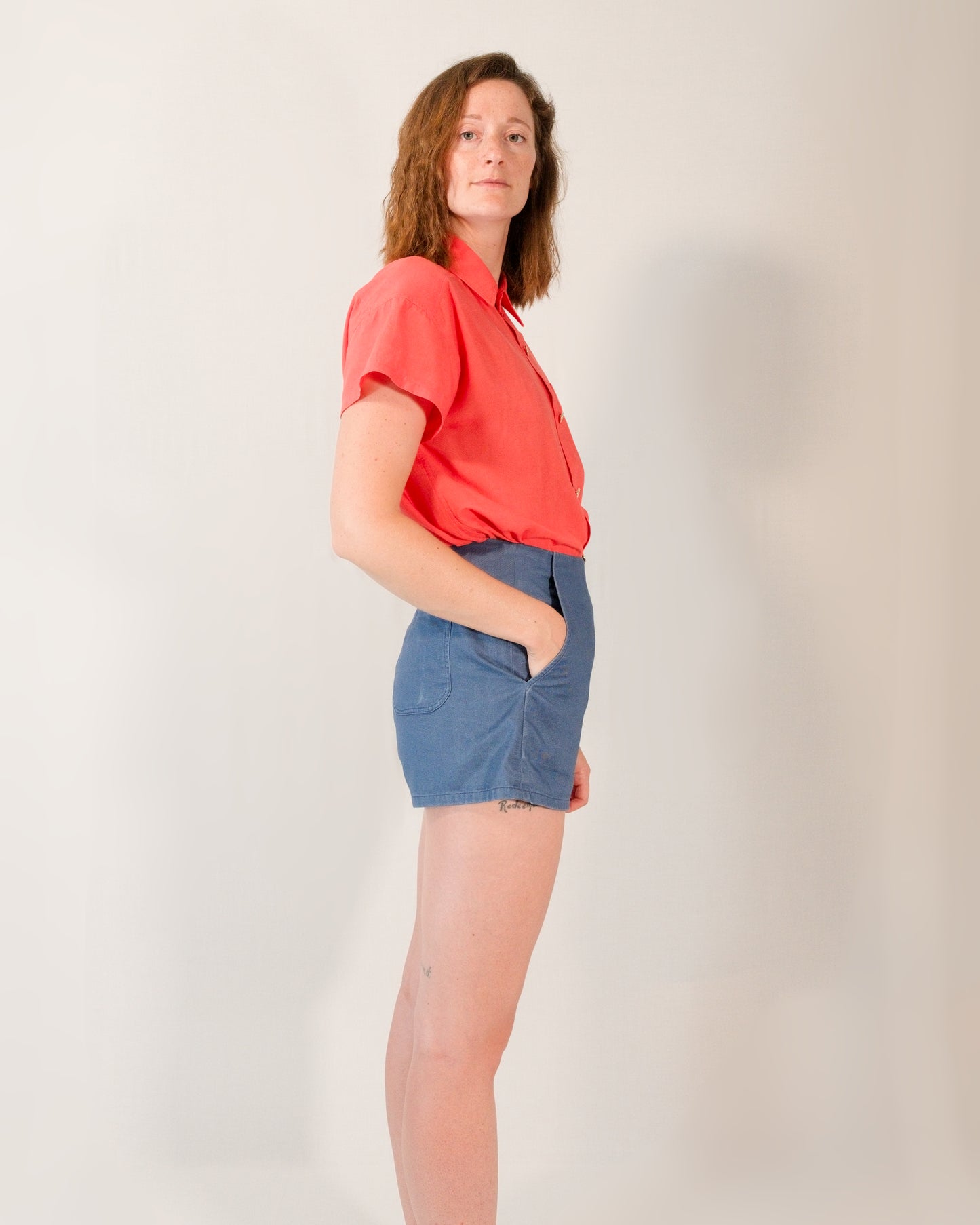 Right side of Kingfisher A-line shorts in dark blue. Model has hand in right pocket.