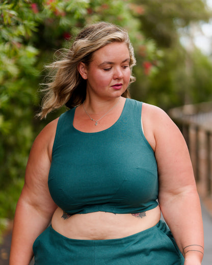 Front of a sleeveless crop top in deep emerald. Two waist darts and a bust dart for shaping.