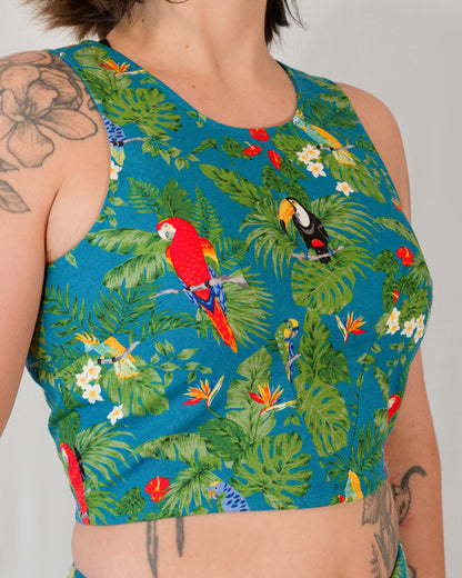 Close-up of sleeveless crop top in a turquoise parrot print showing waist and bust darts meeting at the bust point.