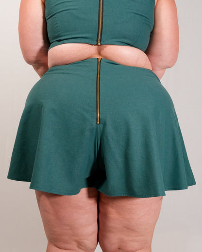 Back of flared shorts in deep emerald with a gold metal zipper closure centre-back. Zipper lines up with zipper on matching crop top.
