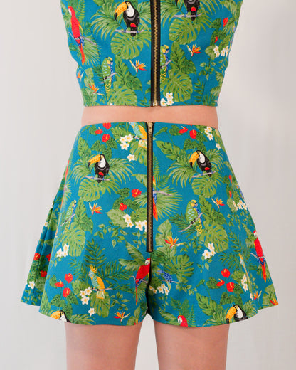 Back of flared shorts in a turquoise parrot print with a gold metal zipper closure centre-back. Zipper lines up with zipper on matching crop top.