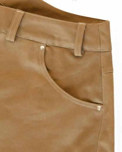Close-up of pocket on khaki brown jeans on a white background
