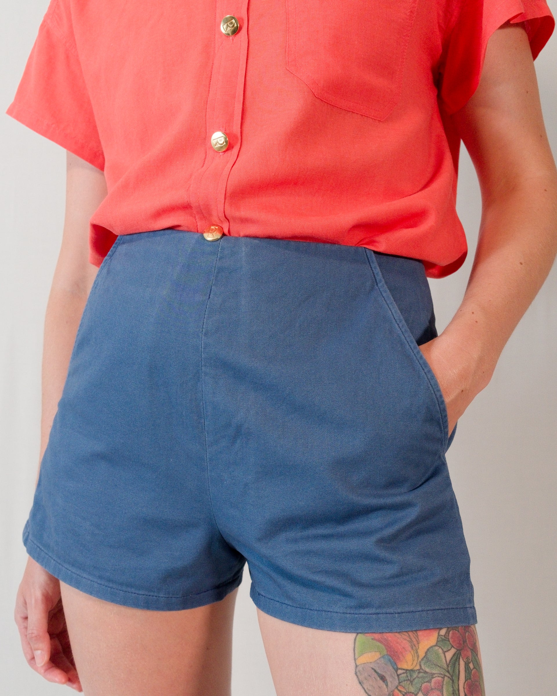 Front of Kingfisher A-line shorts in dark blue. Model has hand in left pocket.