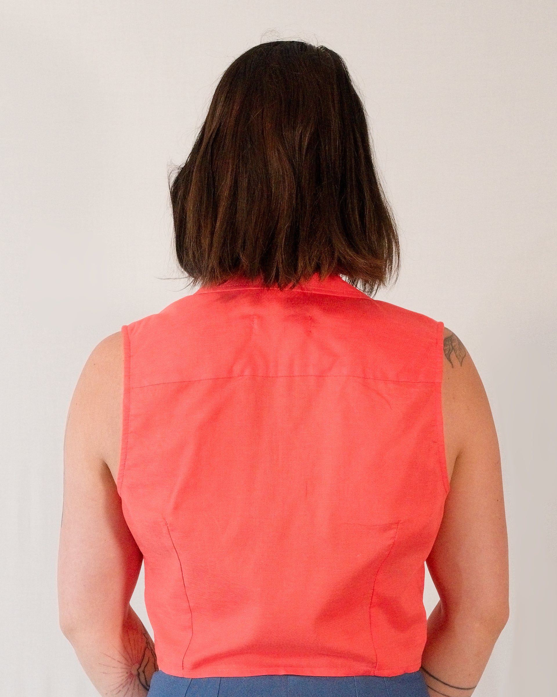 Back of sleeveless blouse in callistemon red. Back darts for shaping.