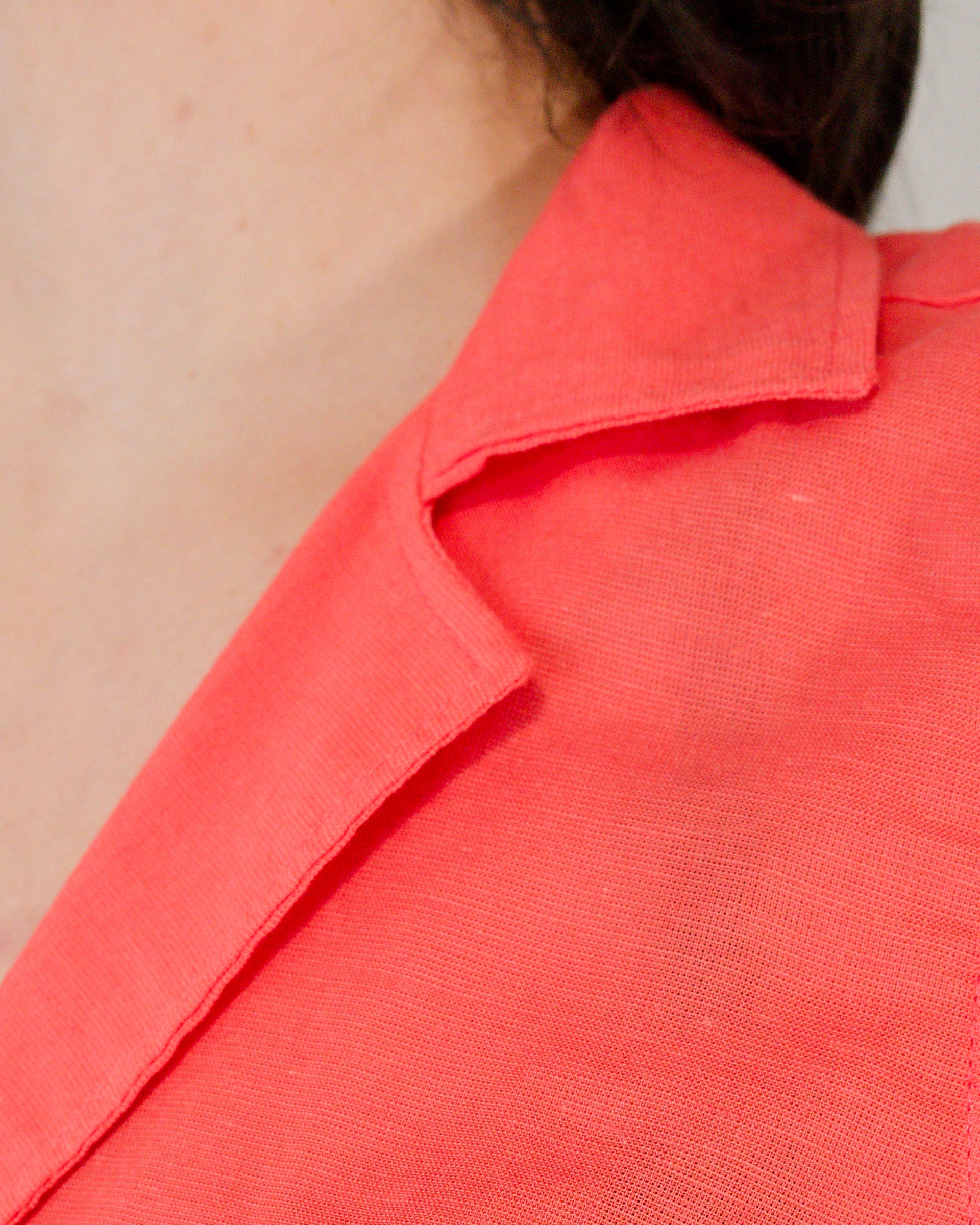 Close-up of camp collar on sleeveless blouse in callistemon red.