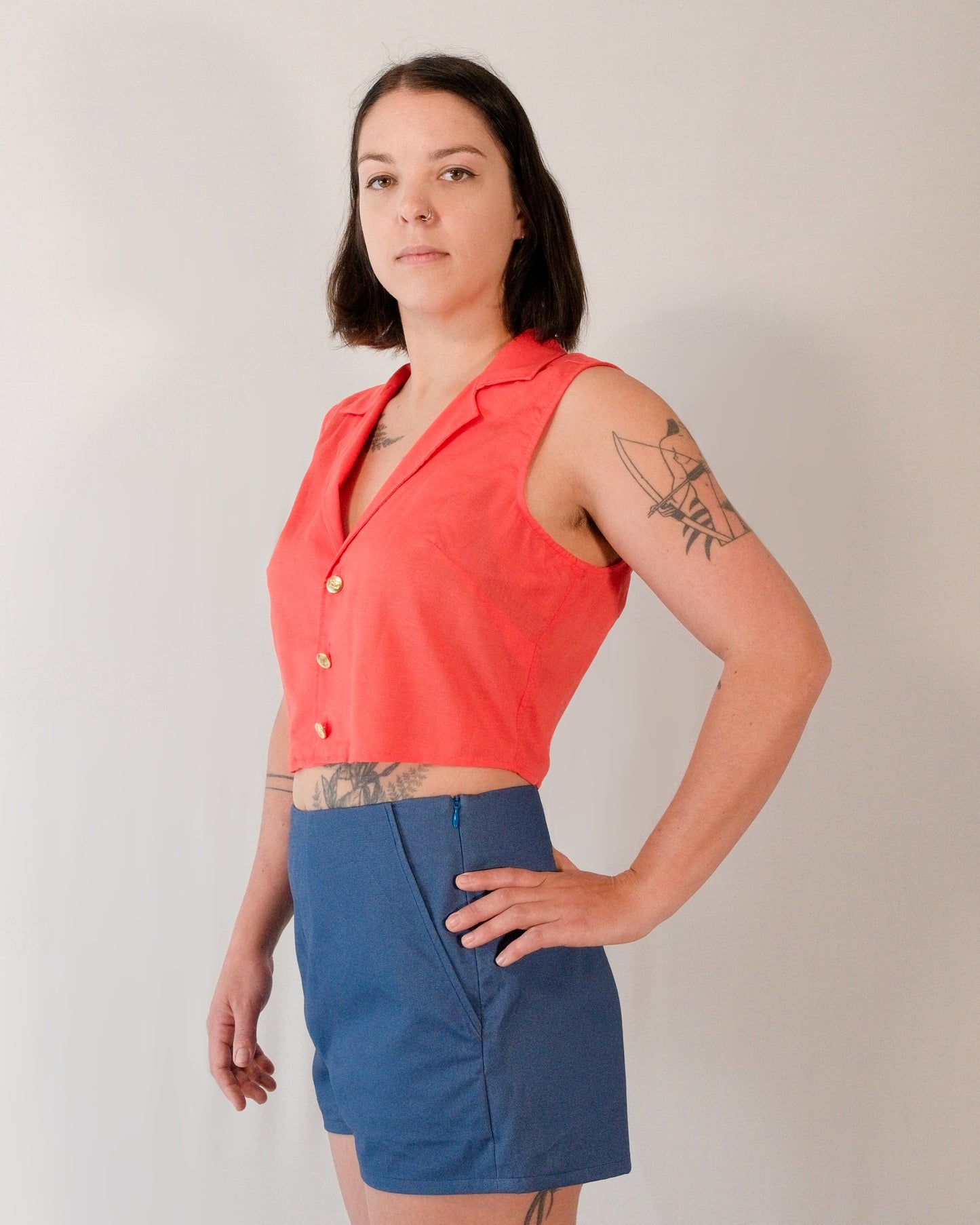 Sleeveless blouse in callistemon red styled with Kingfisher A-line shorts in blue.