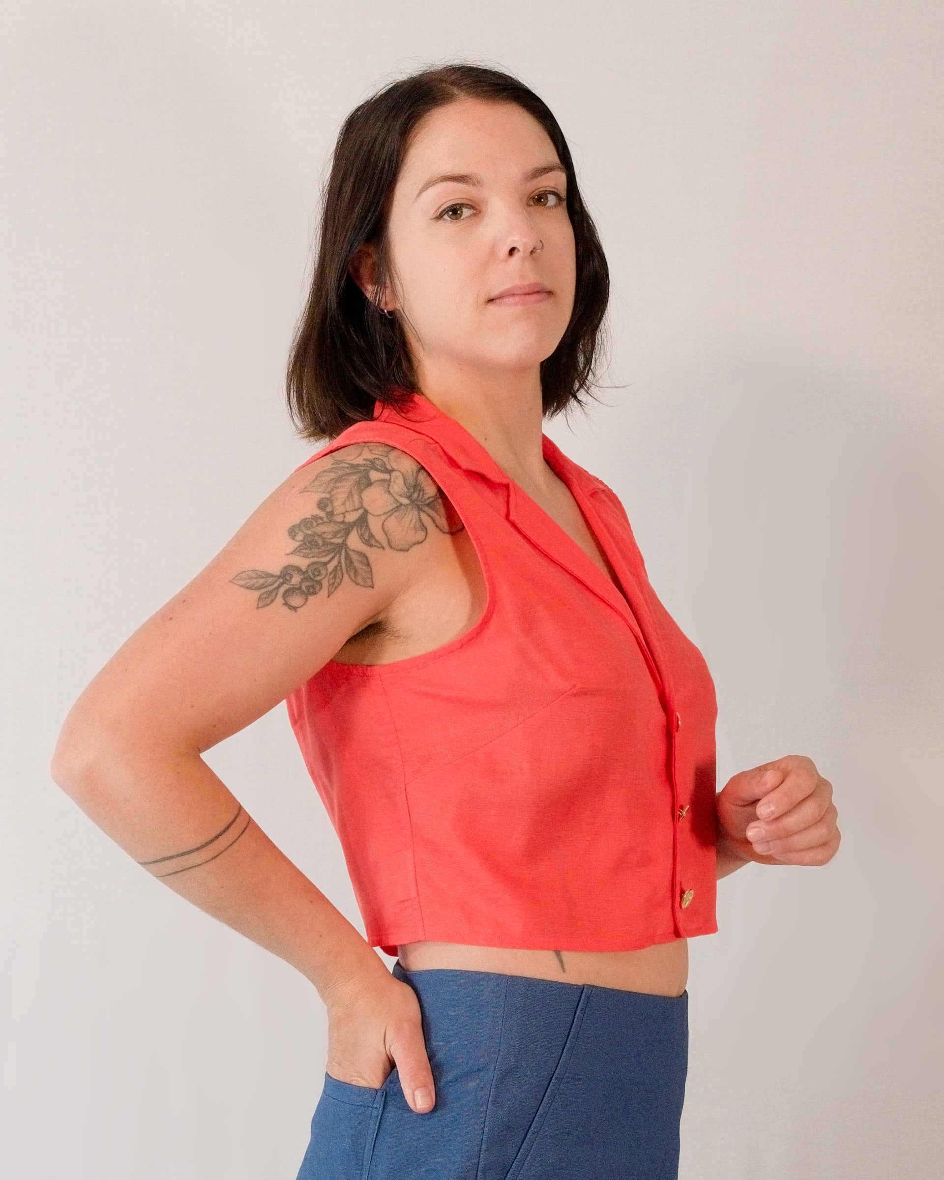 Right side of sleeveless blouse in callistemon red.