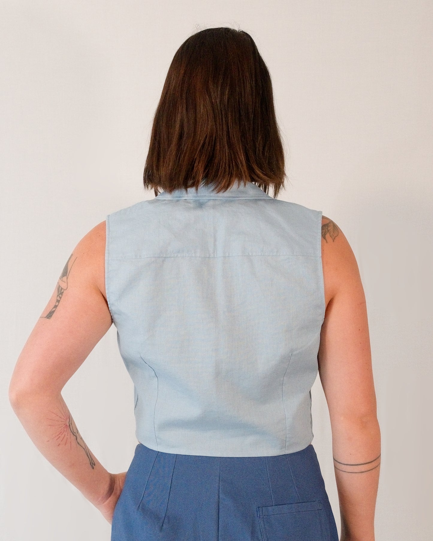 Back of sleeveless blouse in skyline blue. Back darts for shaping.