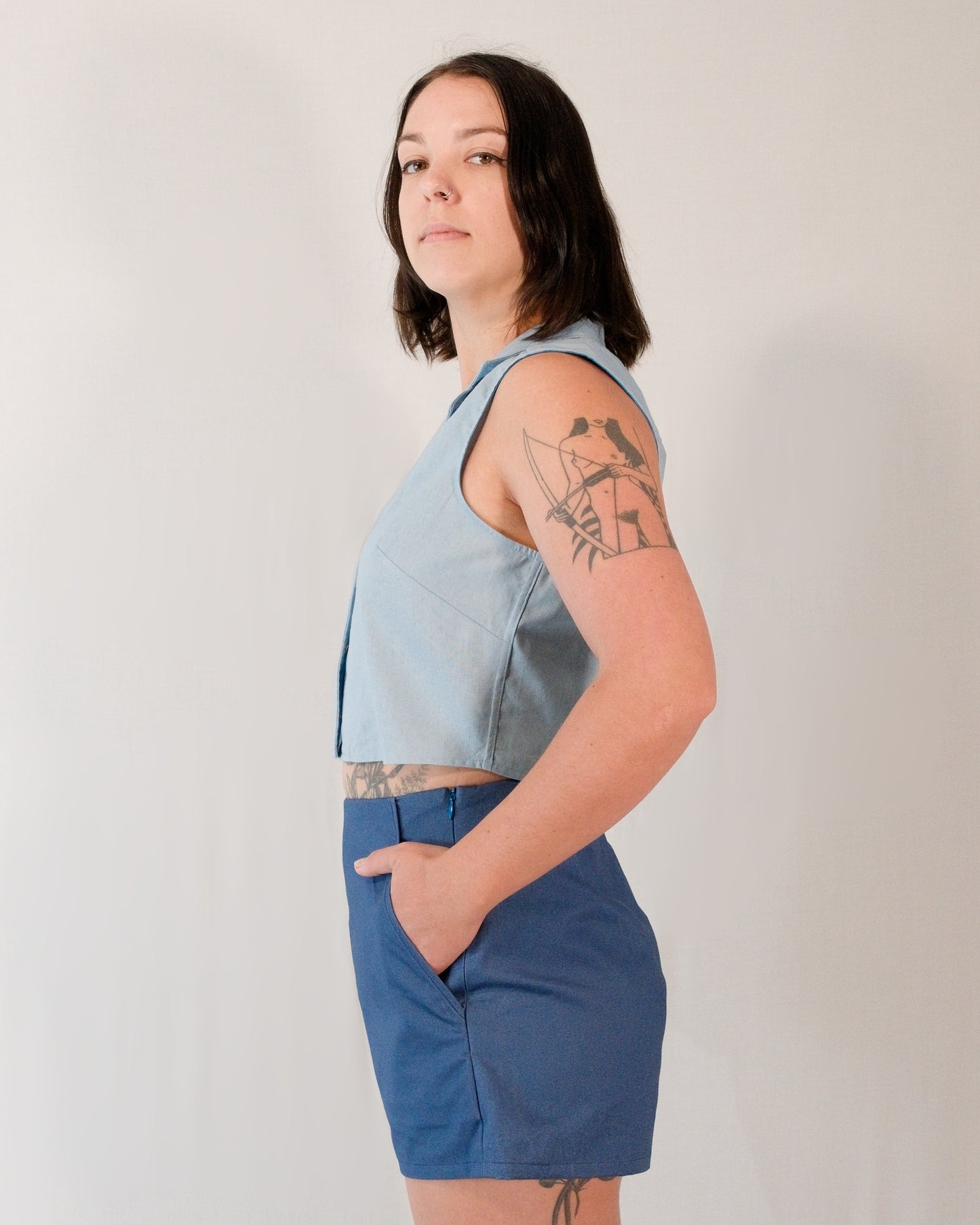 Left side of sleeveless blouse in skyline blue.