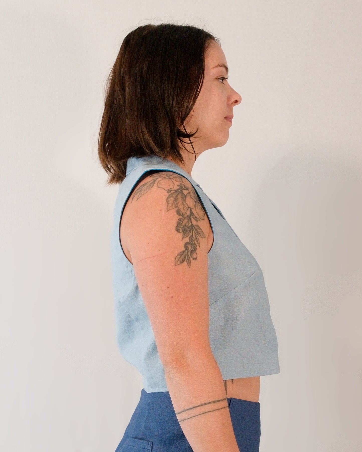 Right side of sleeveless blouse in skyline blue.