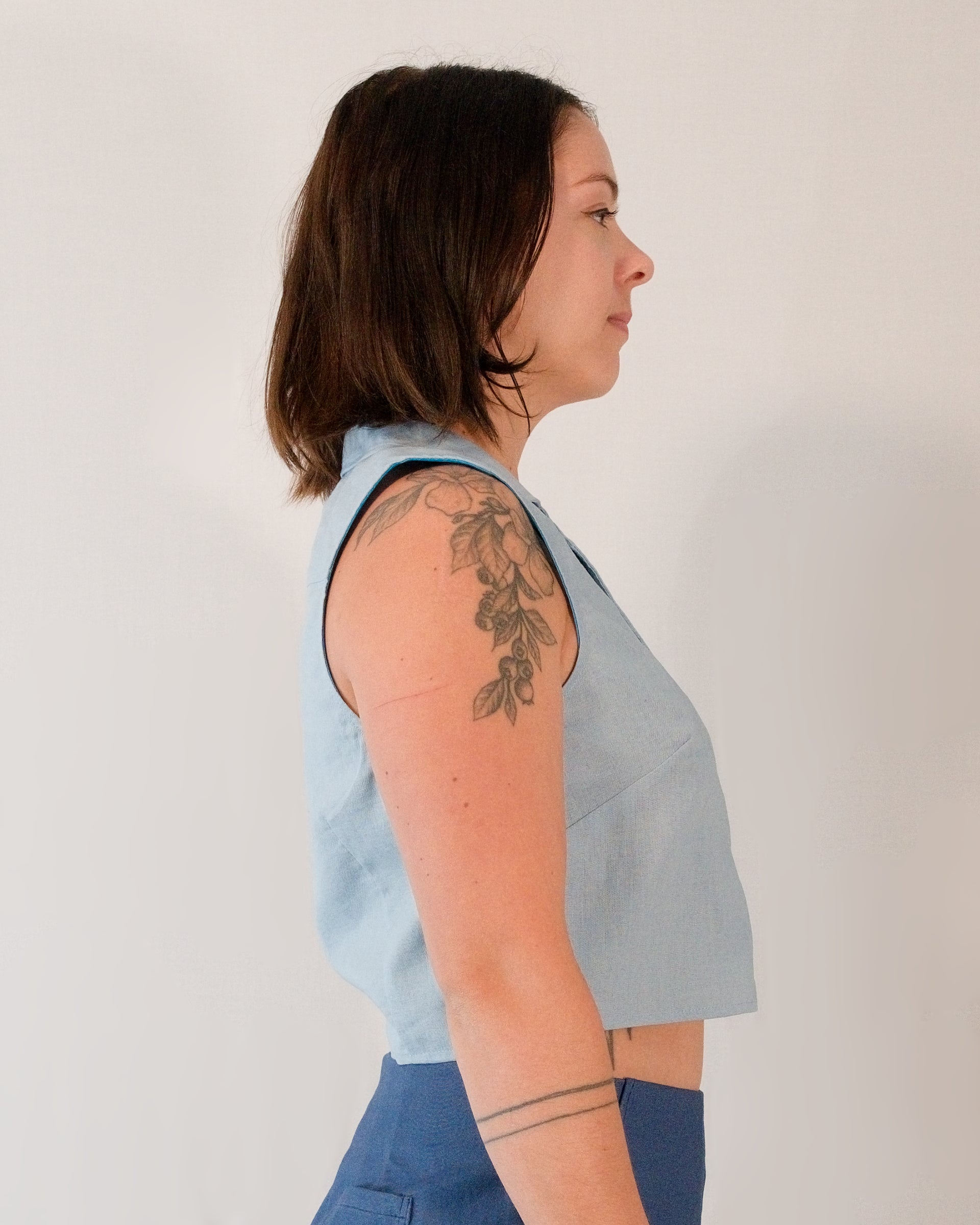 Right side of sleeveless blouse in skyline blue.