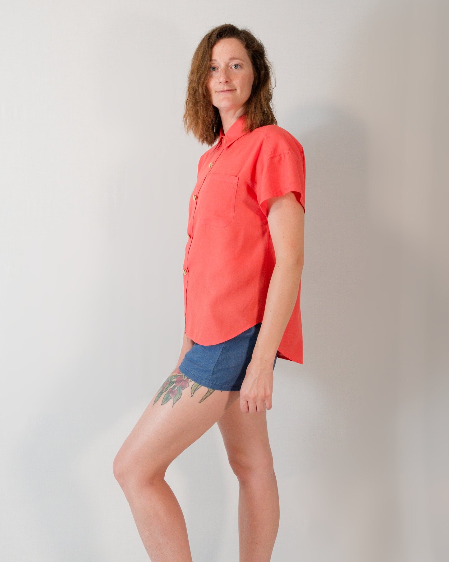 Left side of a short-sleeved blouse in callistemon red.